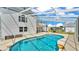 View of backyard pool with rocks under blue sky at 619 Somerset Loop, Auburndale, FL 33823