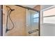 Modern shower with glass door, tiled walls, rainfall shower head, and built-in shelving at 619 Somerset Loop, Auburndale, FL 33823