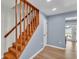 Inviting wooden staircase with a modern design, complemented by the home's updated flooring at 619 Somerset Loop, Auburndale, FL 33823
