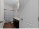 Functional bathroom featuring granite countertop vanity, wood-look flooring, and a shower-tub combo at 647 Chicago Way, Dundee, FL 33838