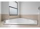 Close up shot of the luxurious corner bathtub at 647 Chicago Way, Dundee, FL 33838