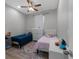 Cozy bedroom featuring two twin beds, a woven cabinet and a ceiling fan at 647 Chicago Way, Dundee, FL 33838