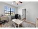 Comfortable bedroom currently set up as an office space, featuring a large window and modern decor at 647 Chicago Way, Dundee, FL 33838