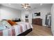 Bright bedroom featuring wood-look flooring, ceiling fan, TV and contemporary furnishings at 647 Chicago Way, Dundee, FL 33838