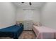 Clean bedroom features two twin beds and a woven cabinet at 647 Chicago Way, Dundee, FL 33838