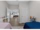 Bedroom features two twin beds and view of the living room at 647 Chicago Way, Dundee, FL 33838