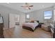 Bright bedroom featuring wood-look flooring, ceiling fan and modern furnishings at 647 Chicago Way, Dundee, FL 33838