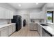 Bright kitchen featuring stainless steel appliances and eat-in bar area at 647 Chicago Way, Dundee, FL 33838