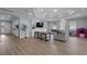 Inviting living room featuring hardwood floors, tray ceiling, built-in shelving, and lots of natural light at 647 Chicago Way, Dundee, FL 33838