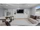 Bright living room features built in shelves, large window, recessed lighting, and light colored wood flooring at 647 Chicago Way, Dundee, FL 33838