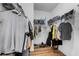 Walk-in closet features built-in shelves and hanging rods at 647 Chicago Way, Dundee, FL 33838
