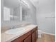 A bathroom featuring double sinks, wood cabinets, and a large mirror at 6819 Glenbrook Dr, Lakeland, FL 33811