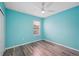 Bedroom with wood-look flooring, ceiling fan, and window for natural light at 6819 Glenbrook Dr, Lakeland, FL 33811