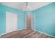 Bedroom featuring wood-look floors, ceiling fan, closet, and entry doorway at 6819 Glenbrook Dr, Lakeland, FL 33811