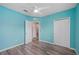 Bedroom with wood-look flooring, ceiling fan, closet, and doorway at 6819 Glenbrook Dr, Lakeland, FL 33811