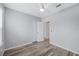 Bedroom with wood-look flooring, ceiling fan, closet, and entry doorway at 6819 Glenbrook Dr, Lakeland, FL 33811