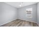 Bedroom with wood-look flooring, ceiling fan, and window at 6819 Glenbrook Dr, Lakeland, FL 33811