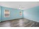 Bright bedroom features wood flooring, large windows, and a ceiling fan at 6819 Glenbrook Dr, Lakeland, FL 33811