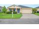 Beautiful home with manicured lawn, complemented by bright blue shutters and a two-car garage at 6819 Glenbrook Dr, Lakeland, FL 33811