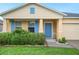 Charming single-story home with a manicured lawn, complemented by bright blue shutters and a blue front door at 6819 Glenbrook Dr, Lakeland, FL 33811