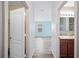Bright hallway featuring wood-look flooring and doorways leading to a bathroom and bedroom at 6819 Glenbrook Dr, Lakeland, FL 33811