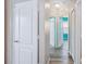 Bright hallway featuring wood-look flooring and multiple doorways at 6819 Glenbrook Dr, Lakeland, FL 33811