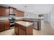 Modern kitchen featuring stainless steel appliances, ample counter space, and wood cabinets at 6819 Glenbrook Dr, Lakeland, FL 33811