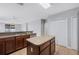 A kitchen features stainless steel appliances, wood cabinets, and a central island at 6819 Glenbrook Dr, Lakeland, FL 33811