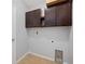 Functional laundry room with overhead cabinets and utility connections, offering practicality at 6819 Glenbrook Dr, Lakeland, FL 33811