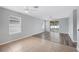 An open concept living room boasts wood flooring, multiple windows, and a ceiling fan at 6819 Glenbrook Dr, Lakeland, FL 33811