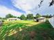 Spacious backyard with mature trees, a shed, and a white fence at 709 N Polk Ave, Fort Meade, FL 33841
