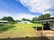 Lush backyard with ample green space, mature trees, and a shed at 709 N Polk Ave, Fort Meade, FL 33841