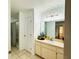 Bright bathroom featuring a vanity with a mirror, cabinets, and tile flooring at 709 N Polk Ave, Fort Meade, FL 33841