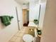 Bathroom featuring tiled floors, a vanity with mirror, and a toilet with green accents at 709 N Polk Ave, Fort Meade, FL 33841