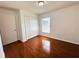 Bedroom with hardwood floors, a window with blinds, and a closet at 709 N Polk Ave, Fort Meade, FL 33841