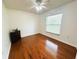 Bedroom featuring hardwood floors, neutral walls, and a window with blinds at 709 N Polk Ave, Fort Meade, FL 33841
