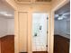 Bright hallway view leading to bedrooms and a bathroom with white tiled floors at 709 N Polk Ave, Fort Meade, FL 33841