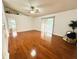 Bright living room featuring hardwood floors, a ceiling fan, and sliding glass doors leading to the backyard at 709 N Polk Ave, Fort Meade, FL 33841