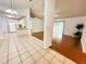Open floor plan featuring tile flooring flowing to wood floors, with access to the kitchen and sliding doors at 709 N Polk Ave, Fort Meade, FL 33841