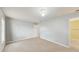 A neutrally decorated bedroom features carpet, a ceiling fan and easy access to an ensuite bathroom at 7337 Hunters Greene Cir, Lakeland, FL 33810