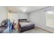 Well-lit bedroom featuring neutral walls, carpet flooring, a door, and a dark bed and desk, creating a versatile space at 7337 Hunters Greene Cir, Lakeland, FL 33810