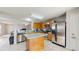 Functional kitchen featuring stainless steel appliances, a central island, tile flooring and seamless connection to the living area at 7337 Hunters Greene Cir, Lakeland, FL 33810