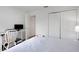 Clean bedroom featuring light colored walls, a desk and spacious closet at 7642 Habersham Dr, Lakeland, FL 33810