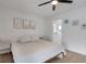 Neutral and clean bedroom features laminate flooring, overhead lighting and calming artwork at 7642 Habersham Dr, Lakeland, FL 33810