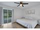 Light and airy bedroom offers backyard pool views and neutral-colored walls, bedding and decor at 7642 Habersham Dr, Lakeland, FL 33810