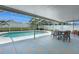 Spacious covered patio with a tiled floor, a dining set, and views of the sparkling pool and backyard at 7642 Habersham Dr, Lakeland, FL 33810