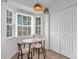 Bright breakfast nook featuring a charming table with seating for two near a window and closet at 7642 Habersham Dr, Lakeland, FL 33810