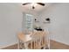 Cozy dining area featuring natural light, floating shelves, and seating for four around a wooden table at 7642 Habersham Dr, Lakeland, FL 33810