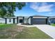 Charming single-story home featuring a well-manicured lawn, a two car garage, and attractive landscaping at 7642 Habersham Dr, Lakeland, FL 33810