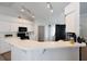 Kitchen with white cabinets and countertops, a black refrigerator, and bright natural light at 7642 Habersham Dr, Lakeland, FL 33810